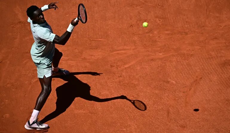 France's Moise Kouame plays a forehand return to Croatia's Marin Cilic during their men's singles match on day 3 of the French Open tennis tournament on Court Simonne-Mathieu at the Roland-Garros Complex in Paris on May 26, 2026. (Photo by JULIEN DE ROSA / AFP)