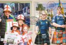 Visual of a family of England supporters and pair of Scotland fans on a background of a postcard that depicts New York and Miami as 2026 World Cup host cities