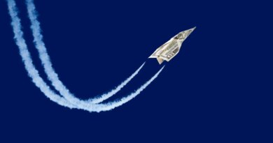paper plane made from a ten-dollar bill 'flying' with contrails