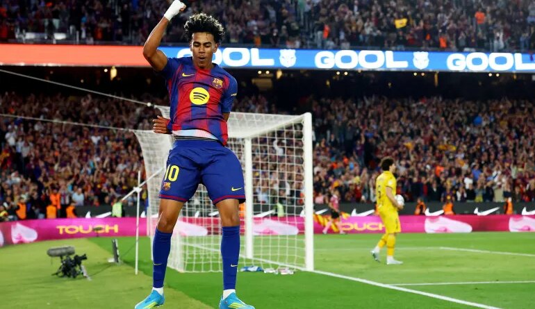 Barcelona's Lamine Yamal celebrates scoring their third goal in the La Liga match against Espanyol