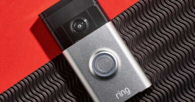 Ring video camera doorbell on a red plain and black textured background.