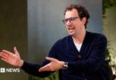 Dario Amodei, co-founder and chief executive officer of Anthropic, speaking during an interview in a room decorated with plants