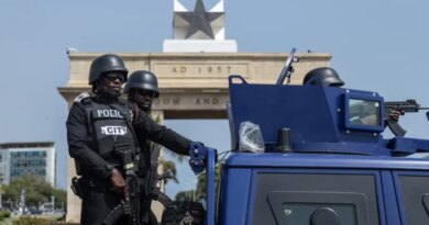 Members of Ghana security forces take part in a joint Show of Force Exercise in Accra, Ghana, 11 December 2025. The exercise featured the Ghana Police Service, Ghana Prisons Service, Ghana National Fire Service, the Customs Division of the Ghana Revenue Authority and the Immigration Service in collaboration with the Ghana Armed Forces, aimed at Police officers on security detail near a police vehicle, with the Ghana Black Star atop a building behind them. [FRANK KPORFOR/Epa]