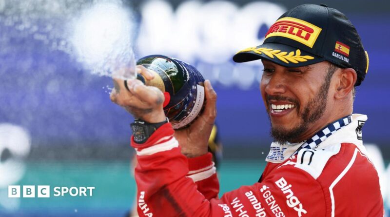 Lewis Hamilton crossing the line with Novak Djokovic waving the flag