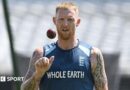 Ben Stokes, wearing a blue England vest, tosses a ball in the air