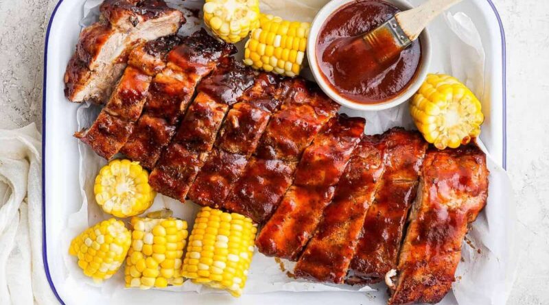 Grilled ribs and corn with bbq sauce.