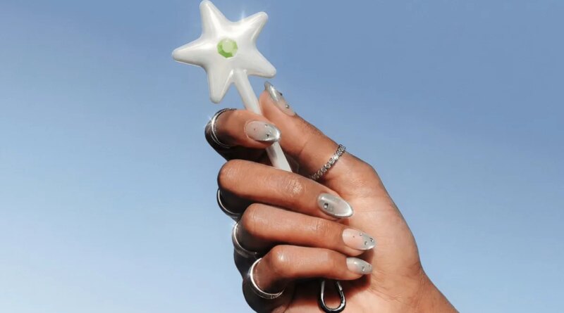 hand holding a star-tipped wand