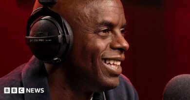 Trevor Nelson smiling while speaking into a radio mic