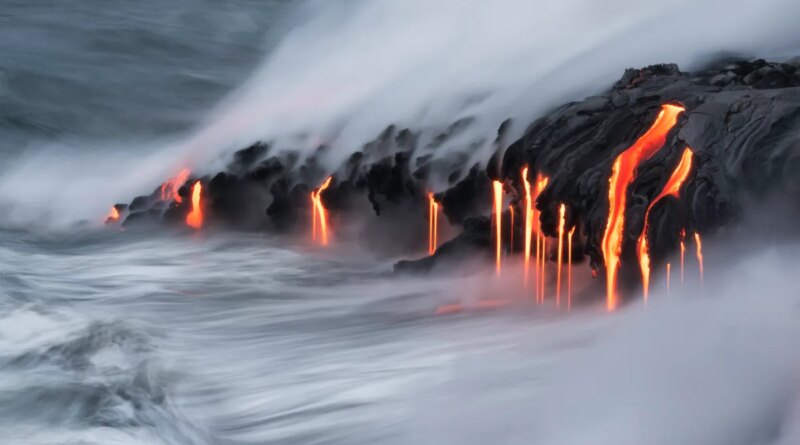 Lava pours into the ocean.