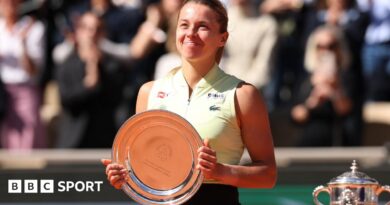 Maja Chwalinska smiles while holding the French Open women's singles runner-up trophy