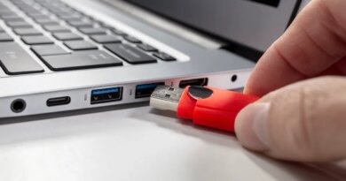 A USB flash drive stick and a laptop computer.
