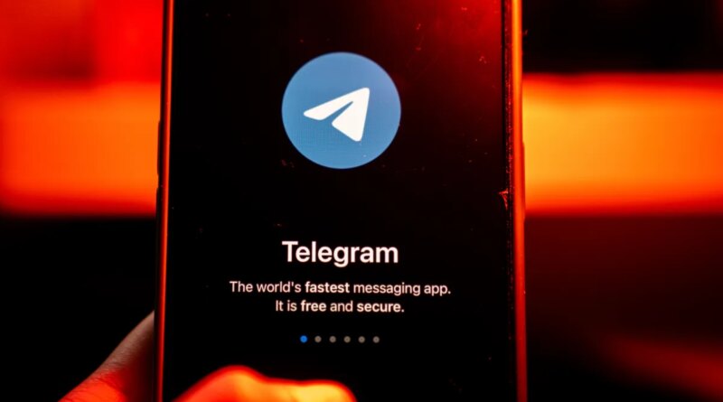 The logo for Telegram chat messenger application arranged on a smartphone.