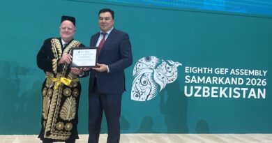 Claude Gascon, interim CEO of the GEF and Aziz Abduhakimov, Minister of Environment of the Republic of Uzbekistan, at the closing ceremony of the Eighth GEF Assembly in Samarkand, Uzbekistan. Gascon was presented with a traditional Uzbek outfit. Credit: Stella Paul/IPS
