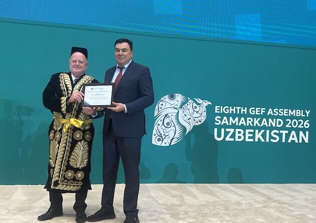 Claude Gascon, interim CEO of the GEF and Aziz Abduhakimov, Minister of Environment of the Republic of Uzbekistan, at the closing ceremony of the Eighth GEF Assembly in Samarkand, Uzbekistan. Gascon was presented with a traditional Uzbek outfit. Credit: Stella Paul/IPS