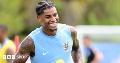 Marcus Rashford smiles during training