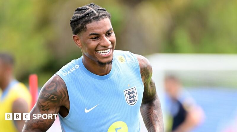 Marcus Rashford smiles during training