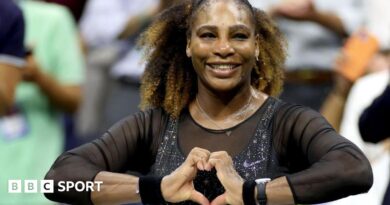 Serena Williams does a heart symbol with her hands while playing at the 2022 US Open