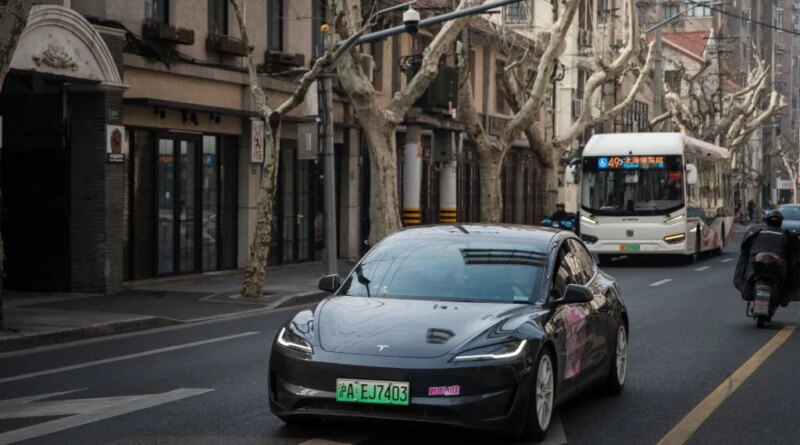 Tesla Model 3 vehicle drives on the street on February 27, 2025 in Shanghai, China.