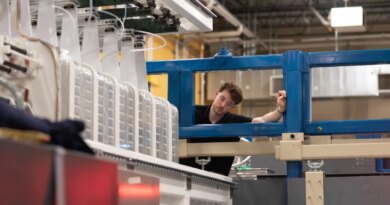 A man inspects a laser system.