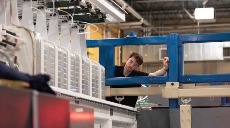 A man inspects a laser system.