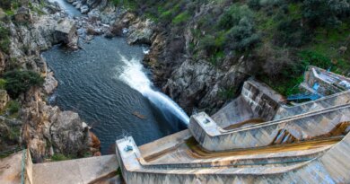 a photo of a dam in Spain seen spilling water.
