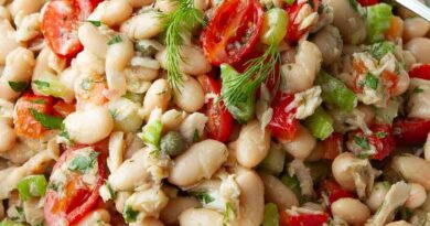 Tuna white bean salad with tomatoes in a white bowl.
