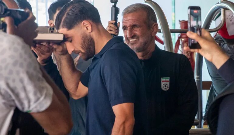 Iran national soccer team member Alireza Jahanbakhsh touches his forehead to the Quran as he departs from the Tijuana Marriott in Tijuana, Mexico on Saturday June 20, 2026. (AP Photo/Gabriela Aoun Angueira)