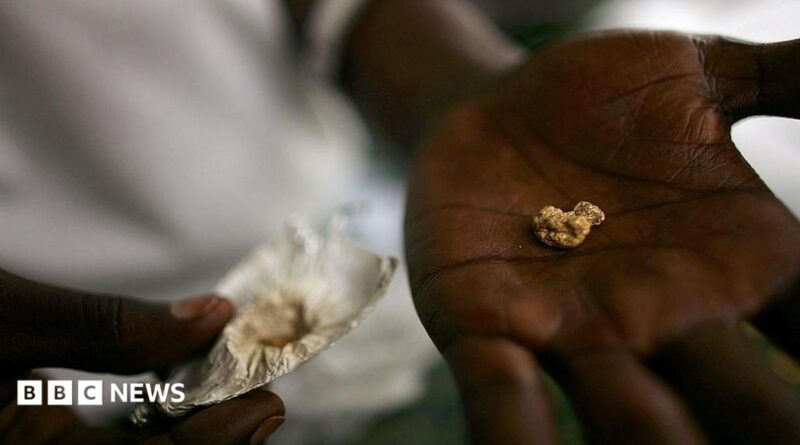 An individual holds a nugget of gold in his palm