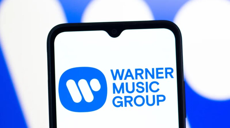 In this photo illustration, the Warner Music Group logo is seen displayed on a smartphone screen.