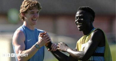 Anthony Gordon and Bukayo Saka smile during training for England at the World Cup
