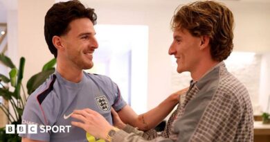 Anthony Gordon greets England team-mate Declan Rice as he arrives in Florida before the 2026 World Cup