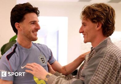 Anthony Gordon greets England team-mate Declan Rice as he arrives in Florida before the 2026 World Cup