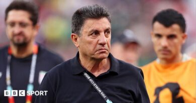 Amir Ghalenoei, wearing a black jumper, frowns