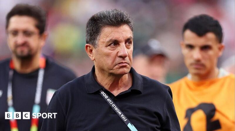 Amir Ghalenoei, wearing a black jumper, frowns