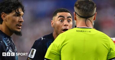 Paraguay forward Miguel Almiron reacts to Dutch referee Danny Makkelie's decision to book him for diving