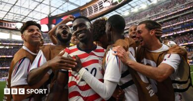 USA players celebrate scoring against Paraguay