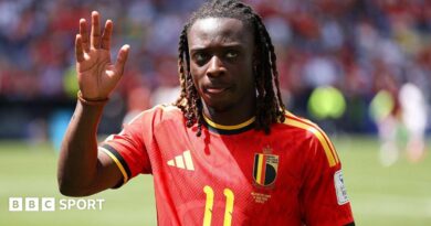 Jeremy Doku waves to the crowd while playing for Belgium