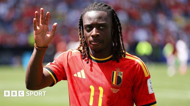 Jeremy Doku waves to the crowd while playing for Belgium