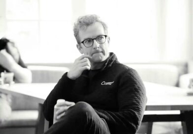 Mike Schroepfer sits in a chair.