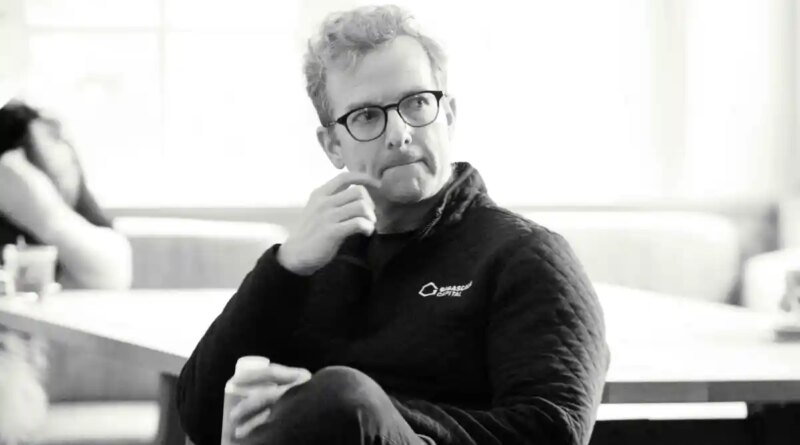 Mike Schroepfer sits in a chair.
