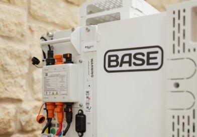 A Base Power battery sits next to a home.