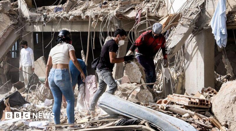 Family members and volunteers search through the rubble after two 17-story buildings in the Belo Horizonte residential complex collapsed in Catia La Mar, La Guaira (Venezuela), on June 26, 2026.