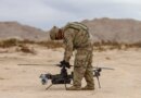 A US soldier prepares an Anduril-built drone for flight during a training exercise.