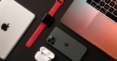 Flat Lay of different apple products on a dark grey background.