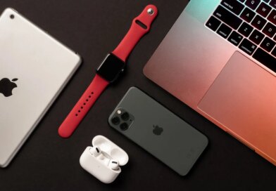Flat Lay of different apple products on a dark grey background.