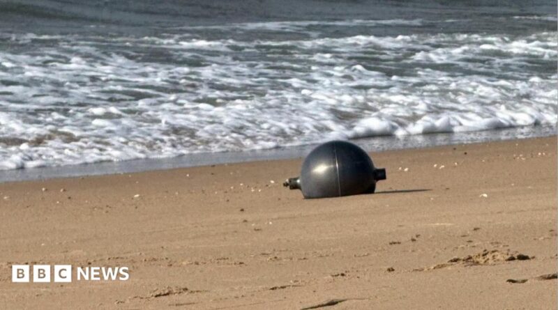 One of the six mysterious large silver spheres washed up on Forrest Beach in Queensland.