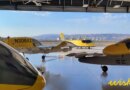 4 yellow wisk evtol in a hangar overlooking hills