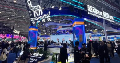 People walk past the Novo Nordisk booth at the 8th China International Import Expo (CIIE) in Shanghai, China November 6, 2025. REUTERS/Andrew Silver