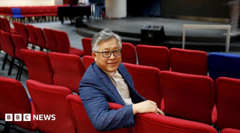 The head pastor of the Zion church in Beijing Jin Mingri poses for picures in the congregation hall of the unofficial Protestant "house" church in Beijing, China, 2018.