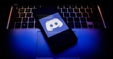 Discord logo displayed on a phone screen and a keyboard.